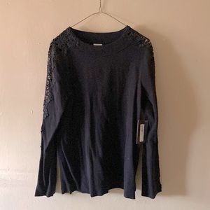 Black sweater with lace sleeves.